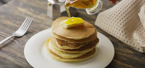 Food and Cooking Concept. Stack of Pancakes with Butter and Warm Maple Syrup in Slow Motion alt