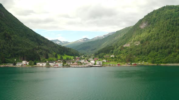 Panorama Of Eidsdal Village With Mountains In Background From Geirangerfjord In Norway. - aerial alt