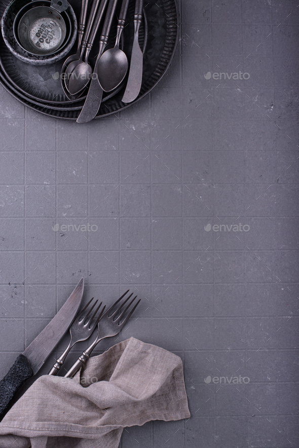 Craft iron tableware in grey background Stock Photo by furmanphoto