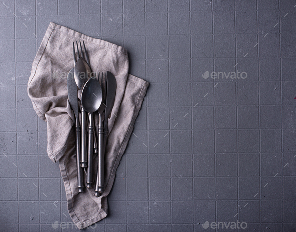 Craft iron tableware in grey background Stock Photo by furmanphoto