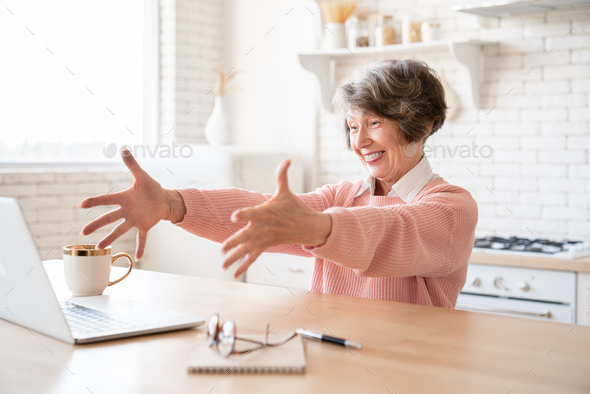 Happy cheerful caucasian grandmother senior old elderly woman winning money lottery, bidding online