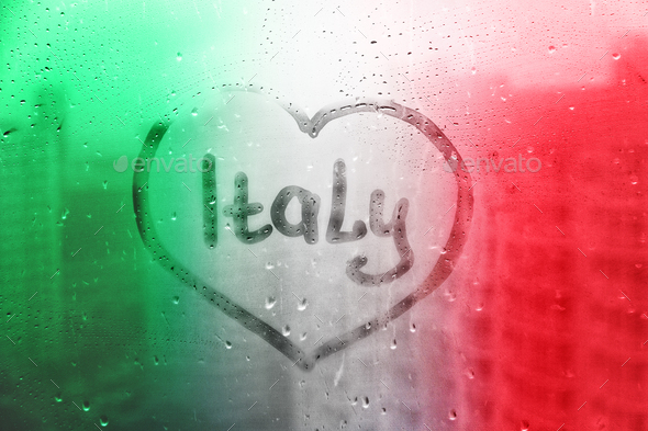 Foggy glass on window with written finger word Italy in heart shape on ...