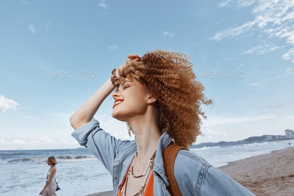 Happy Woman Smiling on Beach, Enjoying Freedom and Adventure with Backpack.  Stock Photo by shotprime