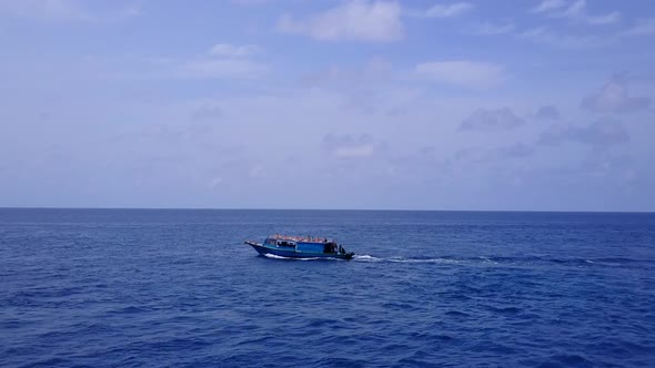 Aerial drone scenery of seashore beach by blue ocean with sand background alt