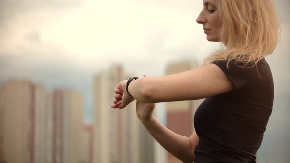 Woman Checking Pulse On Smartwatch.Runner Girl Runnig Wristband.Girl Using Smart Band alt