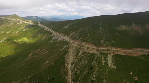 Aerial Shot Road Atop Fagaras Mountains Highway on the Top of Green Hills Beautiful Scenic Landscape