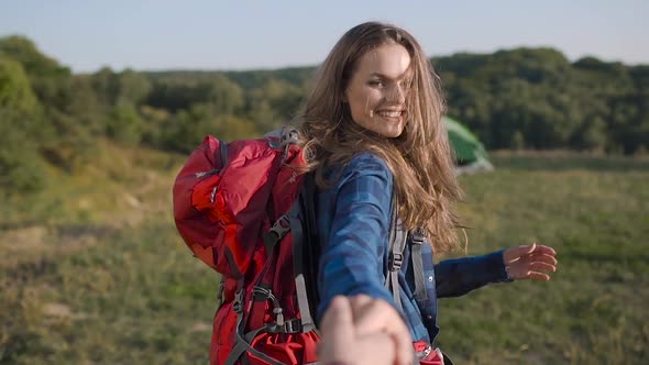Beautiful Tourist Girl Traveling In Nature, Holding Man's Hand alt