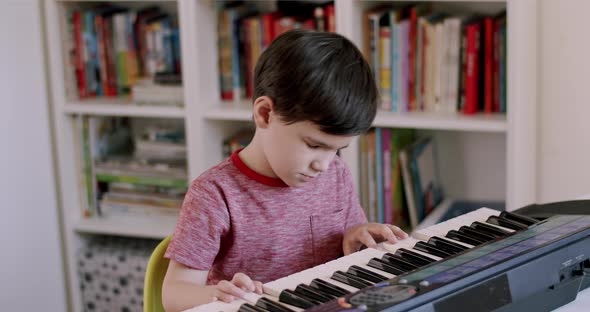 Preschooler Child Devotedly Playing on Electronic Keyboard