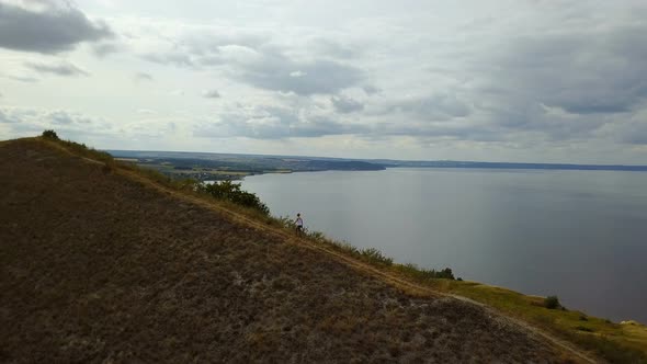 Girl Walks Up The Hill