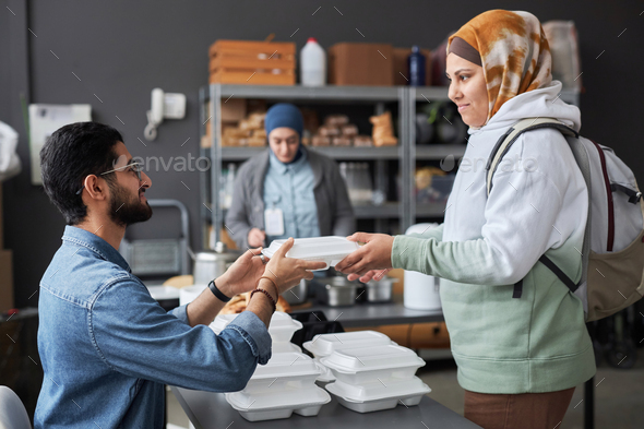 Smiling Middle Eastern Woman Taking Meal at Soup Kitchen