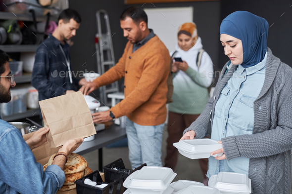 Middle Eastern Woman Receiving Meal at Refugee Center