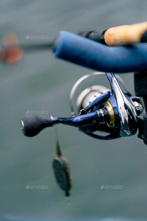 close-up Fishing tackle fishing spinning hooks and baits fisherman on  reservoir feeder free style Stock Photo by guyswhoshoot