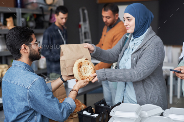 Woman Receiving Free Food at Refugee Help Center