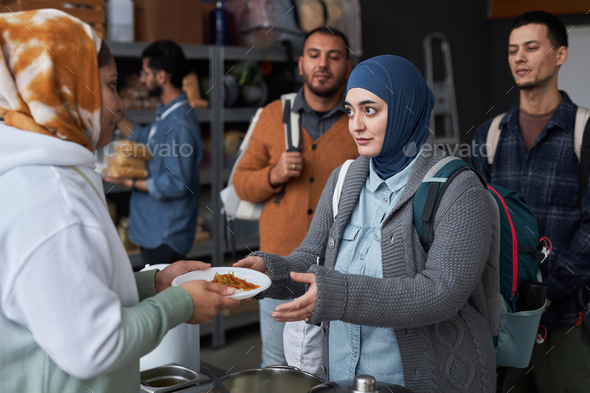Middle Eastern Woman Taking Meal at Refugee Help Center