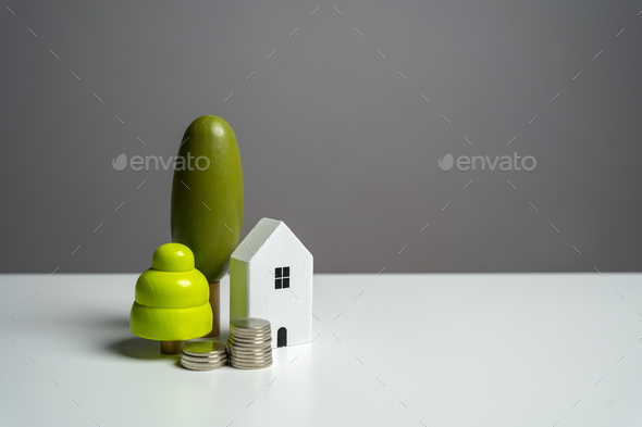 House and stacks of coins. Housing Buying or renting a house.