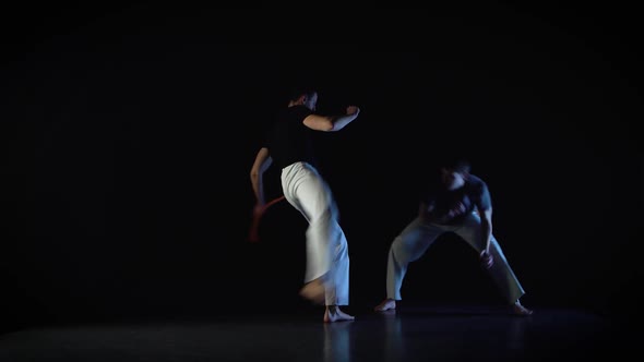 Skilled Men Performing Incredibly Complex of Martial Art of Capoeira. alt