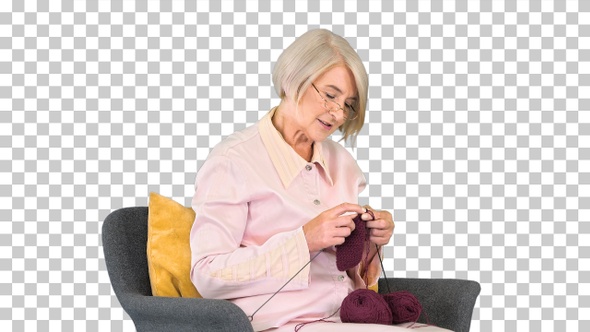Mature grandmother sitting and knitting, Alpha Channel alt