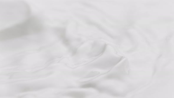Super Slow Motion Detail Shot of Waving Fresh Milk at 1000 Fps alt