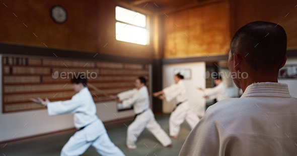Aikido, group and class with sensei, weapon training and wooden sword for self defence exercise. Do