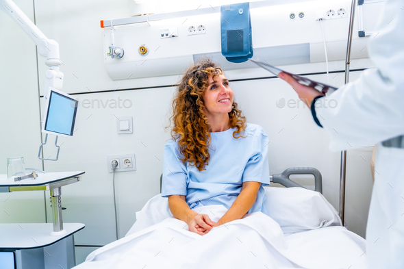 Happy patient on hospital bed talking with a doctor