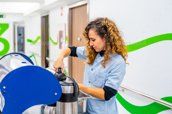 Nurse pouring coffee into cup in the corridor of an hospital