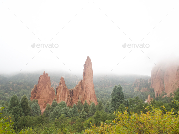 Captivating view of the ethereal beauty of the Garden of the Gods enveloped in a soft mist