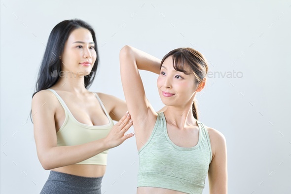 A woman checking the range of motion of her shoulder
