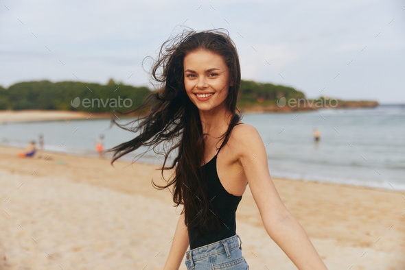 Beauty in Nature: Young Female Model Posing with a Pretty Smile, Enjoying  the Sunny Beach Lifestyle Stock Photo by shotprime