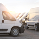 Express delivery, shipping service concept. Delivery vans in a row in the rays of sunset or dawn. - PhotoDune Item for Sale