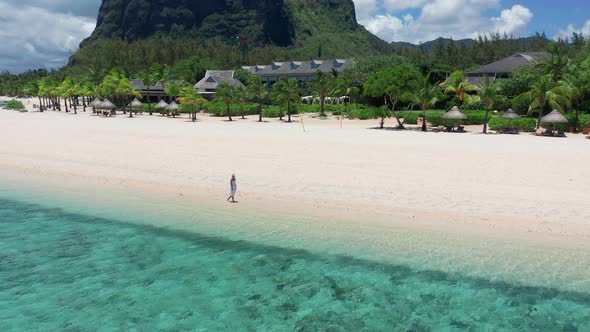 Girl Walking on a White Sand Beach on a Tropical Island in the Mauritius Indian Ocean alt