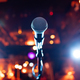 Microphone on stage against a background of auditorium. - PhotoDune Item for Sale