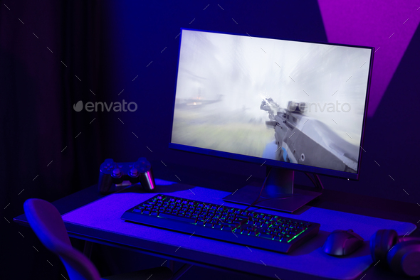 Professional and colorful e-sport gaming studio room with first-person shooter online video game on