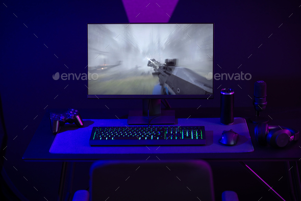 Professional LED lid e-sport gaming studio with first-person shooter online video game on computer