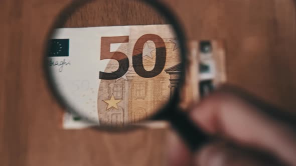 50 Euro Under Magnifying Glass alt