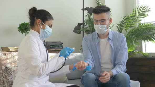 Portrait of pretty young woman doctor using stethoscope examining patient health during visit alt