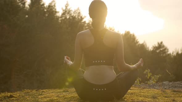 Woman Meditating on the Mountainside