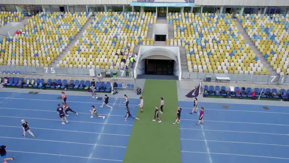 Sport Competition on the Stadium People Running on the Stadium Aerial Video