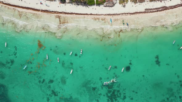 Establisher Shot of Busy Tropical Beach with Empty and Sailing Boats Along with Unrecognized Tiny alt