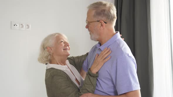 Closeup of a Beautiful Elderly Married Couple Enjoying Time Together and Dancing in the Living Room alt
