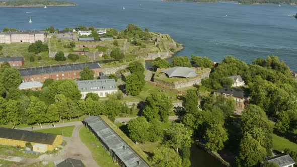 Aerial view over the Suomenlinna fortress island, sunny, summer day, in Helsinki, Finland - reverse, alt