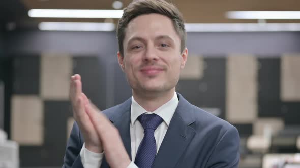 Portrait Shot of Happy Businessman Clapping Applauding alt