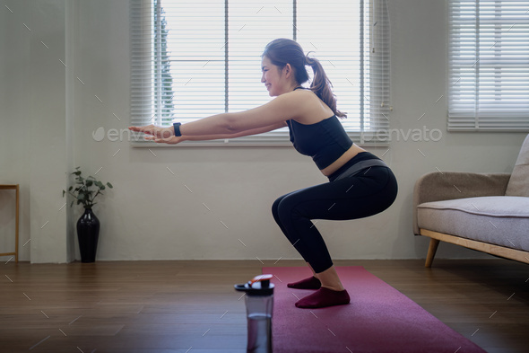 Fitness, yoga and gym at home concept. Young woman doing