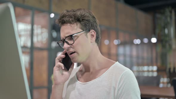 Close Up Shoot Upset Guy Talking on Smartphone alt