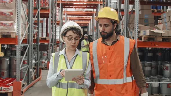 Warehouse Supervisor and Colleague Walking and Talking alt