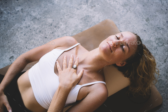 Young woman with black hair band lying on floor Stock Photo by GaudiLab