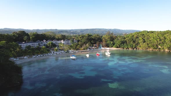 Aerial view of boats in cove by resort  in Jamaica alt