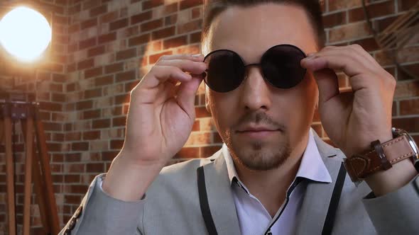 Man Puts on Sunglasses alt