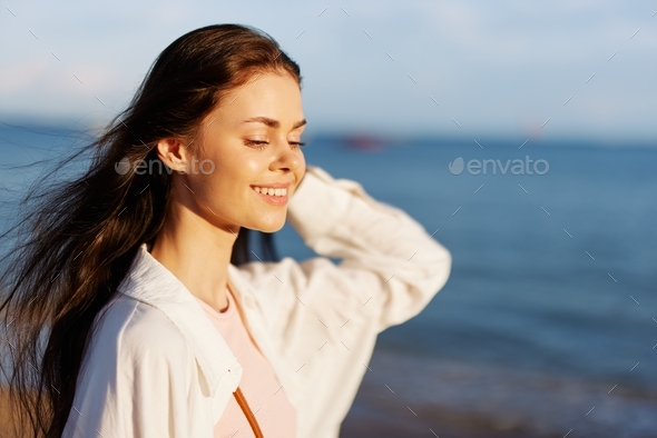 Woman portrait smile with teeth freedom vacation walking on the beach ...