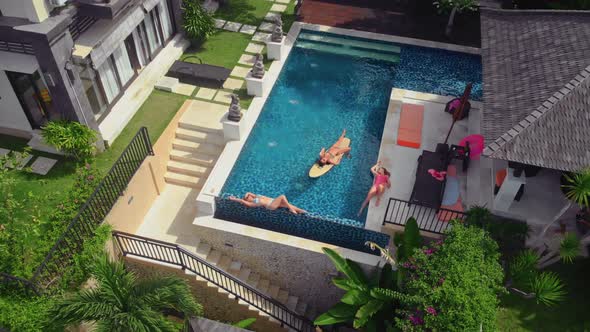 Flight Overlooking the Villa and Girls Near Uluwatu Town on Bali Island Indonesia alt