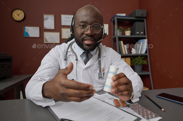 Professional Physician Prescribing Medicine to His Patient During Video Call